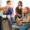 Students eating their lunch together in a hallway, girl in wheelchair smiling